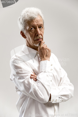 Image of The serious businessman against gray background.