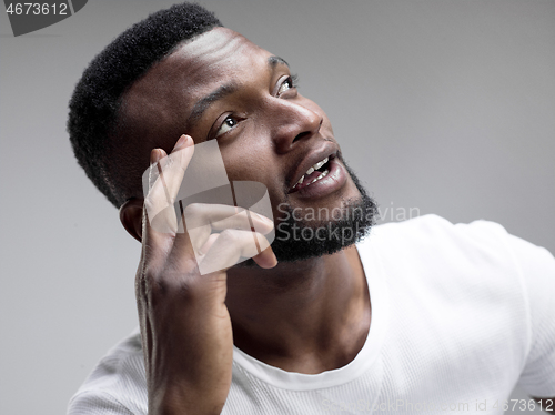 Image of Young serious thoughtful businessman. Doubt concept.