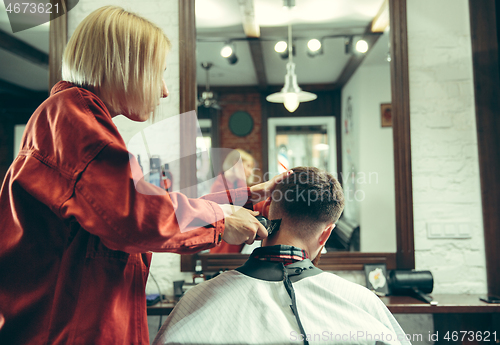 Image of Client during beard shaving in barber shop