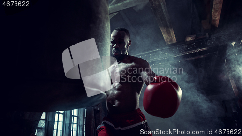 Image of Hand of boxer over black background. Strength, attack and motion concept