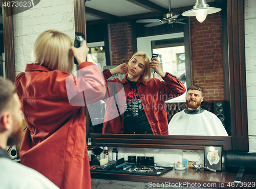 Image of Client during beard shaving in barber shop