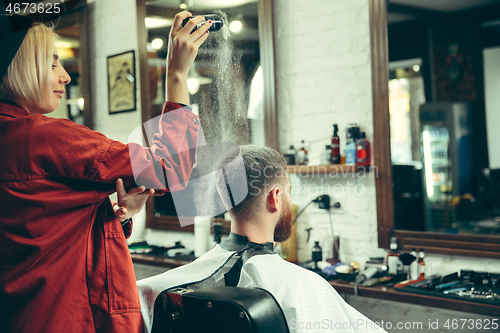 Image of Client during beard shaving in barber shop