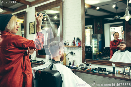 Image of Client during beard shaving in barber shop