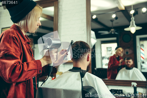 Image of Client during beard shaving in barber shop