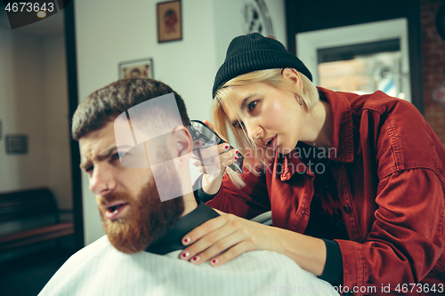 Image of Client during beard shaving in barber shop