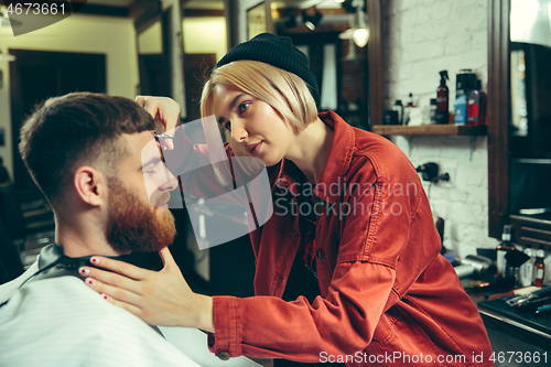 Image of Client during beard shaving in barber shop