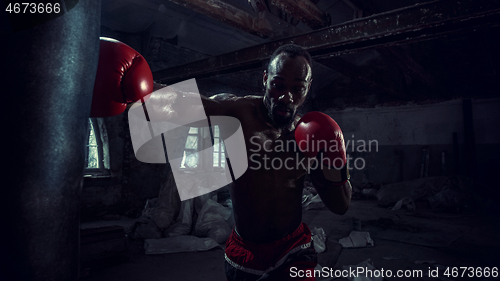 Image of Hand of boxer over black background. Strength, attack and motion concept