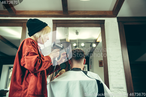 Image of Client during beard shaving in barber shop