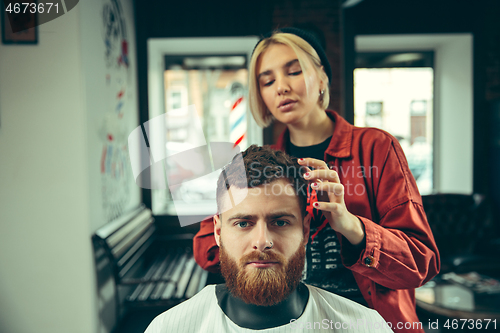 Image of Client during beard shaving in barber shop