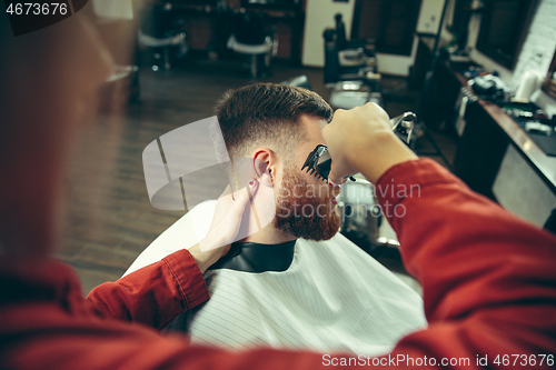 Image of Client during beard shaving in barber shop