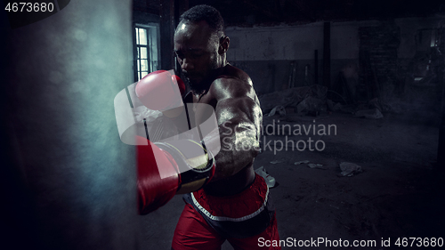 Image of Hand of boxer over black background. Strength, attack and motion concept