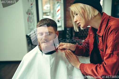 Image of Client during beard shaving in barber shop