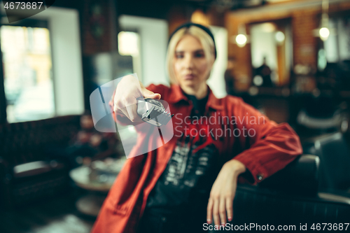 Image of Female barber in barber shop