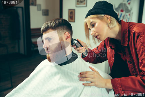 Image of Client during beard shaving in barber shop