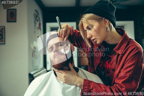 Image of Client during beard shaving in barber shop