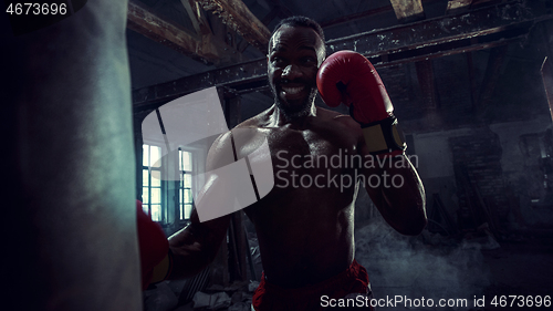 Image of Hand of boxer over black background. Strength, attack and motion concept