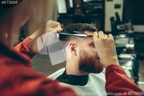 Image of Client during beard shaving in barber shop