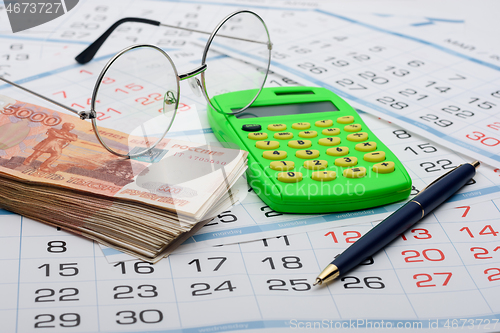 Image of Concept of savings savings for old age, money, pen, calculator and glasses
