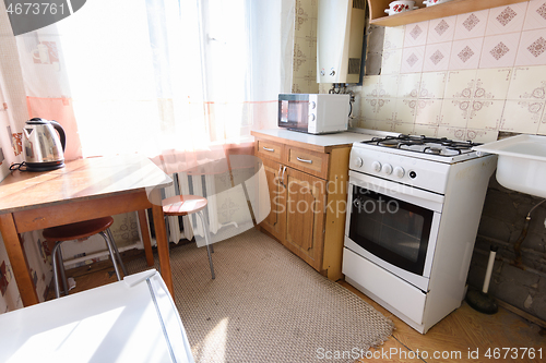 Image of General view of an old kitchen unit in the interior of a kitchen in need of repair