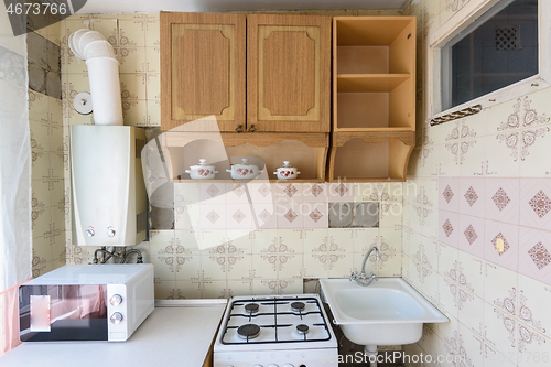 Image of A fragment of an old kitchen set in the interior of a kitchen in need of repair