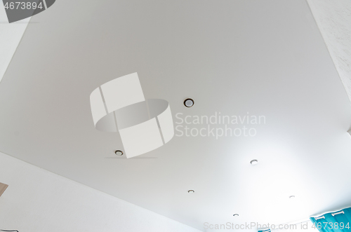 Image of Fragment of the room\'s interior - white matte stretch ceiling with a series of spotlights