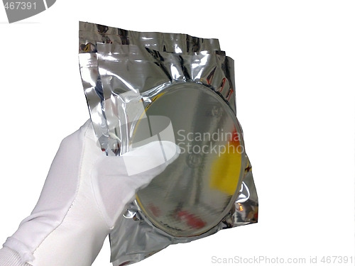 Image of Hand in a white glove with a package