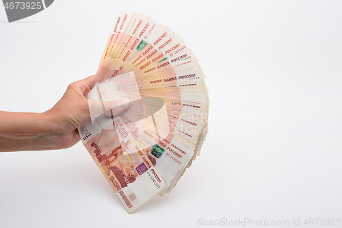 Image of Hand fanned out the kidney of five thousandth Russian bills