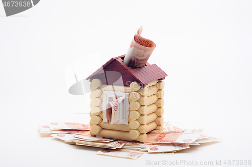 Image of Five thousandth Russian banknotes stick out from the house, the house stands on a bundle of banknotes