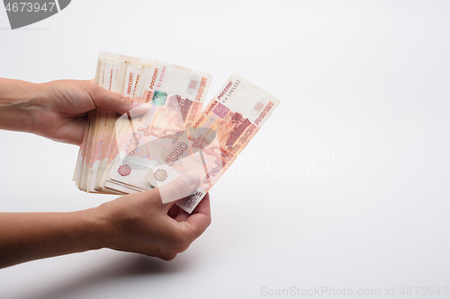 Image of Hands count a five thousandth Russian banknotes