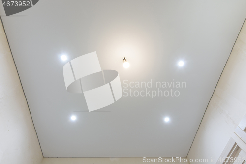 Image of Matte vinyl stretch ceiling in the interior of the room, spotlights included