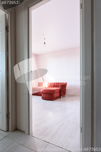 Image of Entrance to an empty bedroom with an old sofa