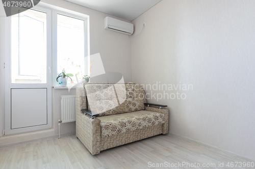 Image of View of part of the room at the exit to the balcony, sofa and air conditioning