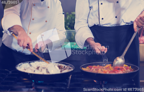 Image of team cooks and chefs preparing meals