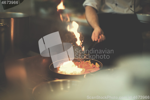 Image of Chef doing flambe on food