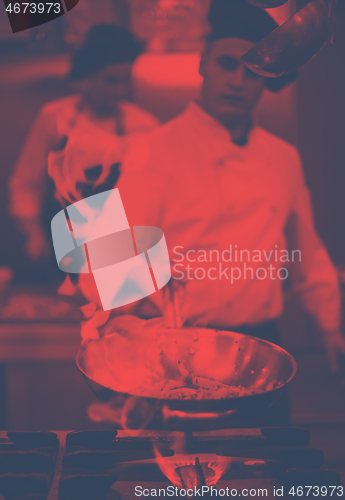 Image of Chef doing flambe on food