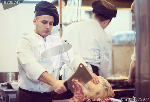 Image of chef cutting big piece of beef