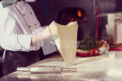 Image of chef throwing up pizza dough