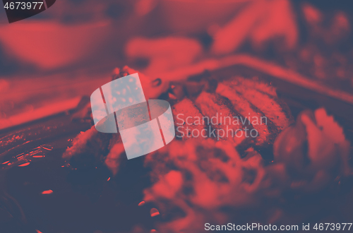 Image of Juicy slices of grilled steak on wooden board