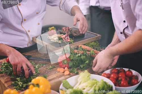 Image of team cooks and chefs preparing meal