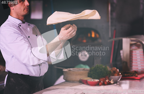 Image of chef throwing up pizza dough
