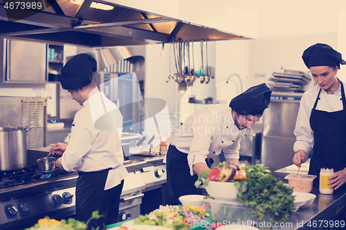 Image of team cooks and chefs preparing meals