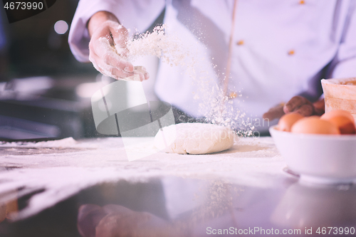 Image of chef hands preparing dough for pizza