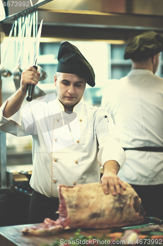 Image of chef cutting big piece of beef