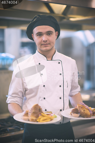 Image of Chef showing dishes of tasty meals