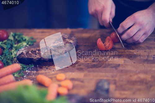 Image of closeup of Chef hands preparing beef steak
