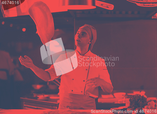 Image of chef throwing up pizza dough