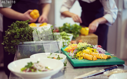 Image of team cooks and chefs preparing meals