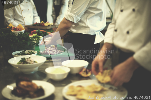 Image of team cooks and chefs preparing meal