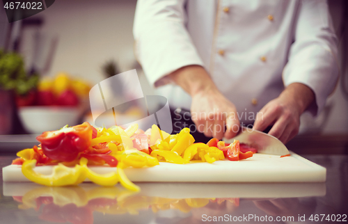 Image of Chef cutting fresh and delicious vegetables