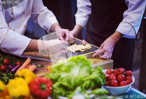 Image of team cooks and chefs preparing meal